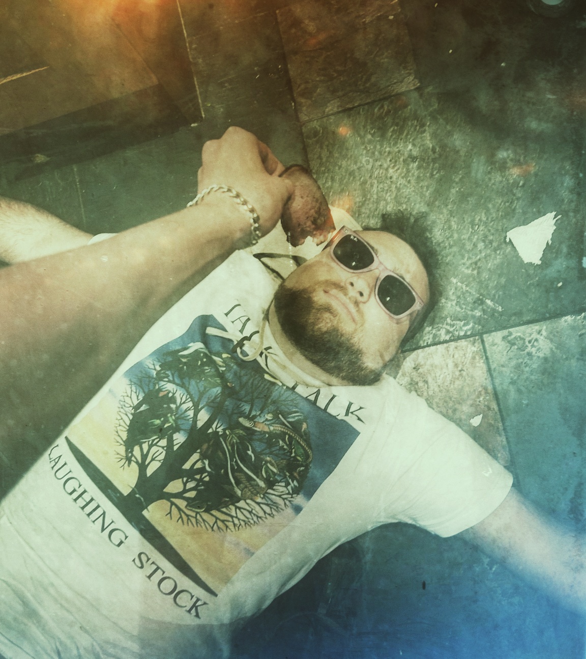 Wearing sunglasses and a Talk Talk Laughing Stock T-shirt.